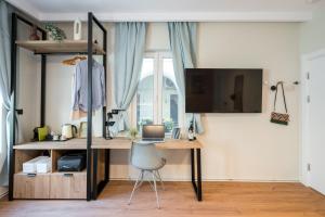 a room with a desk with a computer and a chair at Luxury Apart-Hotel in Bucharest