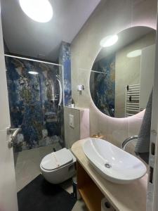 a bathroom with a sink and a mirror at Apartmani Kiki 2 in Pale +13 photos