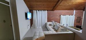 a living room with a couch and two windows at Casa Campestre la Martina in La Honda