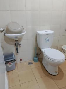 a bathroom with a toilet and a sink at HOST HOMES-SANDY LANE in Tacloban