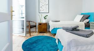 Postel nebo postele na pokoji v ubytování Kurkowa GamaHome Cozy Apartments