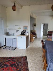 a kitchen and living room with a table and a counter at La Pause Bleue in Saint-André-de-Majencoules +32 photos