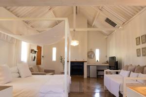 a bedroom with a bed and a living room at Conductor's Inn in Tsumeb