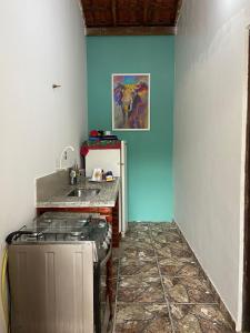 a kitchen with a stove and a refrigerator at Casa em Sorocaba in Sorocaba