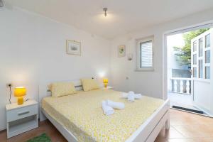a bedroom with a bed with two towels on it at Villa NV View 22 by aneo travel in Novi Vinodolski +26 photos