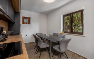 a kitchen and dining room with a table and chairs at Villa NV View 22 by aneo travel in Novi Vinodolski