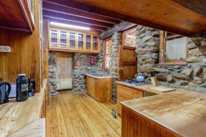 a kitchen with wooden floors and a stone wall at Green Silence in McGregor