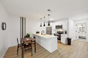 a kitchen with white cabinets and a table and chairs at Market View Residence 601 I 1 Bedroom 1 Bathroom in Wilmington +17 photos