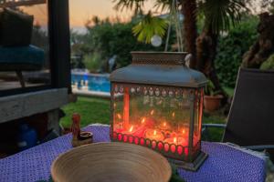 a lantern sitting on top of a table at Jacaranda Cottage in Malinska