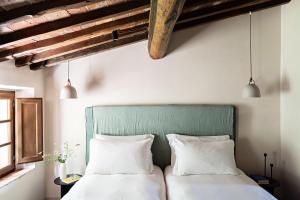 Voodi või voodid majutusasutuse Pieve Aldina Relais & Châteaux toas