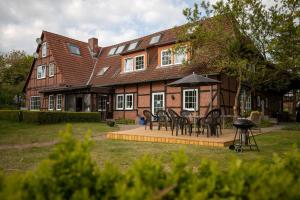 a house with a table and chairs in front of it at Gästehaus Wedework in Wedemark +5 photos