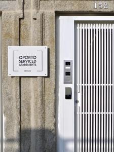 a sign on the side of a building with a door at Oporto Serviced Apartments - Miragaia II in Porto