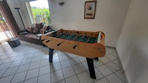 a ping pong table in the corner of a living room at Soleil de Provence in Nyons