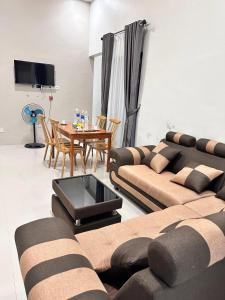 a living room with a couch and a table at Livi Guest House in Sekupang