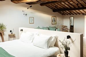 Voodi või voodid majutusasutuse Pieve Aldina Relais & Châteaux toas