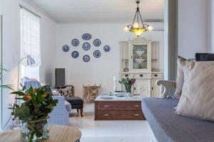 a living room with a couch and a table at Archodiko Palio Klima - Infinite Blue Elegance in Neo Klima +38 photos
