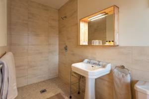a bathroom with a sink and a mirror at Dolphin Beach Lodge - Rental Property in Clifden +35 photos