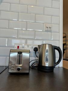 a coffee maker and toaster sitting on a table at 1 bed flat in central Cambridge in Cambridge