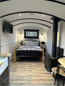 a bedroom with a bed and a fireplace at Flying Scotsman Unique Carriage Pet Friendly! Lazy Spa can be available upon request with additional cost of 40 in Bridgend