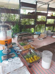 a table with a tray of food and a drink at Monaburi Boutique Resort in Rawai Beach