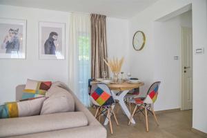a living room with a couch and a table with chairs at Villa Piedra by aneo travel in Kraljevica