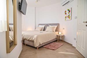 a bedroom with a bed and a television in it at Villa Piedra by aneo travel in Kraljevica +22 photos