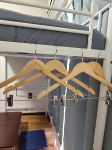 a chandelier made of wood hanging from a loft bed at JKhouse4 in Fukuoka