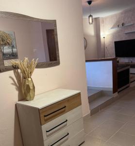 a living room with a dresser and a mirror at Near the lake in Kastoria