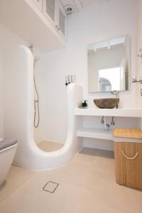 a white bathroom with a sink and a mirror at Ambiente Villas 3Βd-Agios Ioannis in Agios Ioannis Mykonos