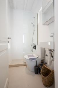 a white bathroom with a toilet and a sink at Ambiente Villas 3Βd-Agios Ioannis in Agios Ioannis Mykonos +24 photos