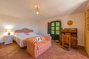 a bedroom with a bed and a chair and a desk at Cortijo Cantarranas - Tarifa in Tarifa +24 photos
