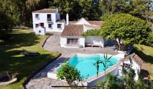 a house with a swimming pool in a yard at Cortijo Cantarranas - Tarifa in Tarifa