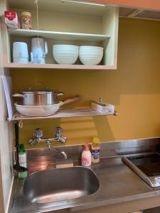 a kitchen counter with a sink and bowls on a shelf at JKhouse4 in Fukuoka +6 photos