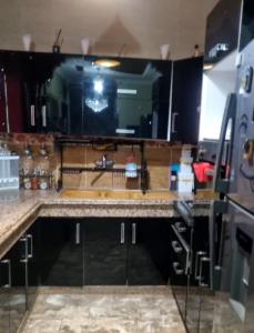 a kitchen with a sink and a counter top at Appartement très calme a 10 mn de mehdia in Kenitra