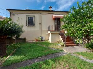 a house with a staircase in front of a yard at Relax on the Sea in Pizzo