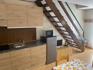 a kitchen with a sink and a staircase at TONALE 3 in Passo del Tonale