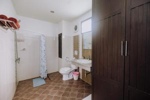 a bathroom with a toilet and a sink at Monaburi Boutique Resort in Rawai Beach