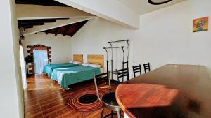a bedroom with a bed and a table at Los Temazcales de Xochitepec in Xochitepec