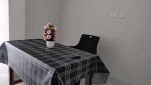 a table with a vase of flowers on it at Sivasarass rooms in Trivandrum