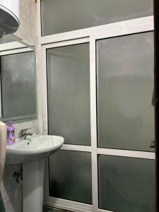 a bathroom with three windows and a sink at Апартамент 8 in Varna City +12 photos