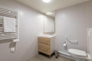 a white bathroom with a sink and a toilet at OVELIA Ermont - Le Pavillon d'Amélie in Ermont +3 photos