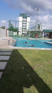 a swimming pool with two people in the water at Hospedagem COP30 in Ananindeua
