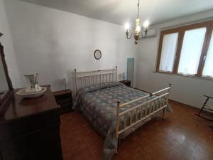 Un dormitorio con una cama, un escritorio y ventanas. en Casa SoleLuna, en Siena