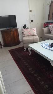 TV a/nebo společenská místnost v ubytování Appartement Beatrice Tantana #direkt am Meer#