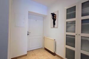 einen Flur mit einer weißen Tür und einem Heizkörper in der Unterkunft Villa Kreuzbergl - Apartment in Klagenfurt am Wörthersee