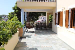 a view from the balcony of a house with a patio at Eleni's Guest House in Patitiri