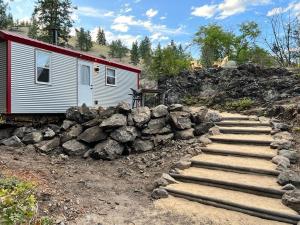 a stone path leading to a red and white building at Runaway Express Coach in Oliver