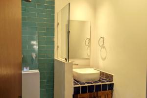 a bathroom with a sink and a mirror at Stunning 2BR, with outdoor living space and ocean view in Sayulita +30 photos