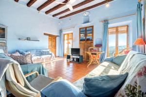 a living room with two couches and a tv at Can Gasol - Casa Rural del Siglo XVI in Guialmons