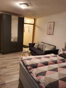 a living room with a bed and a couch at Schönes Modernes Apartment in der Nähe vom Bahnhof in Tübingen